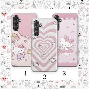 May include: Three smartphone cases featuring Hello Kitty designs. Case 1 is light pink with a picnic scene. Case 2 has a white and pink heart pattern with small Hello Kitty faces. Case 3 is light pink with Hello Kitty, flowers, and strawberries.