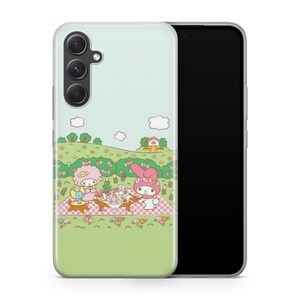 May include: A green and blue phone case with a cartoon image of two bunnies having a picnic in a field with flowers and a house in the background.