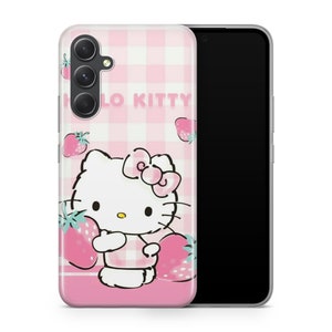 May include: A pink and white checkered phone case with a Hello Kitty design. Hello Kitty is holding a strawberry and there are strawberries scattered around the case. The case is for a smartphone with a camera bump.