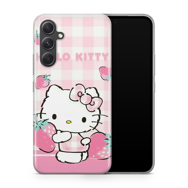 May include: A pink and white checkered phone case with a Hello Kitty design. Hello Kitty is holding a strawberry and there are strawberries scattered around the case. The case is for a smartphone with a camera bump.