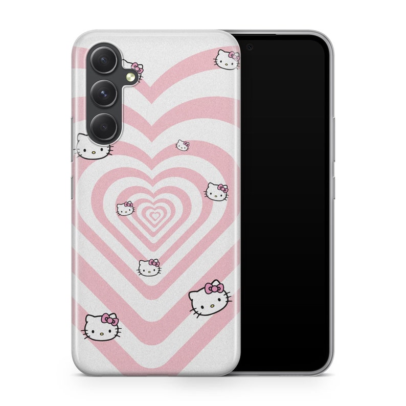 May include: A smartphone case featuring a repeating pink and white heart tunnel pattern with multiple small Hello Kitty character icons scattered across the surface. The case has cutouts for a triple camera system on the upper left side.