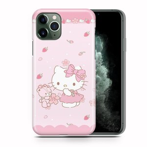 May include: Pink iPhone case with a Hello Kitty design. Hello Kitty is wearing a pink dress and a pink bow. She is holding a small pink bear. The background is pink with white flowers and strawberries.