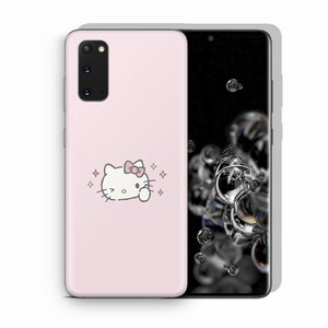 以下が含まれることがあります： ピンクの携帯電話ケースにハローキティのデザインが施されています。ケースにはピンクのリボンをつけた白いハローキティとピンクの背景があります。携帯電話ケースはSamsung Galaxy S20 Ultra用です。