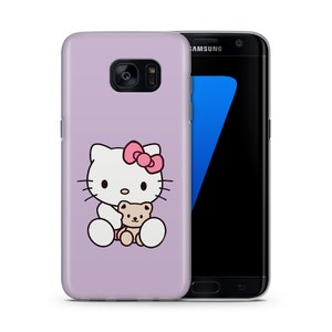 May include: A lavender phone case featuring a cartoon image of Hello Kitty holding a teddy bear.