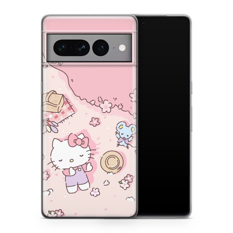 May include: A pink phone case with a Hello Kitty design. Hello Kitty is laying down with a pink bow and a blue dress. There is a small blue mouse character and a straw hat on the case.