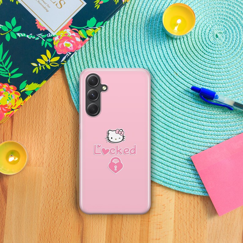 May include: A pink phone case with a Hello Kitty design and the text "L'♡cked" with a pink heart and a padlock.