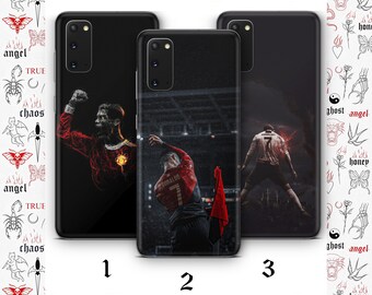 May include: Three phone cases with different designs featuring a soccer player in a red and black uniform. The cases are black with a clear plastic window to show the design. The designs are all different, but they all feature the same soccer player in a different pose. The text "RONALDO" is visible on one of the cases.