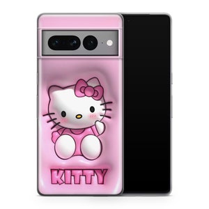 May include: A pink phone case with a Hello Kitty cartoon design, including a pink bow and dress. The word "KITTY" is printed in pink at the bottom. The case is shown on a black smartphone.