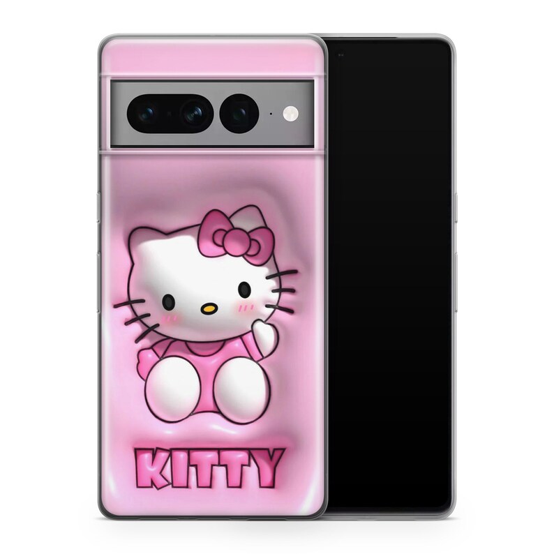May include: A pink phone case with a Hello Kitty cartoon design, including a pink bow and dress. The word "KITTY" is printed in pink at the bottom. The case is shown on a black smartphone.