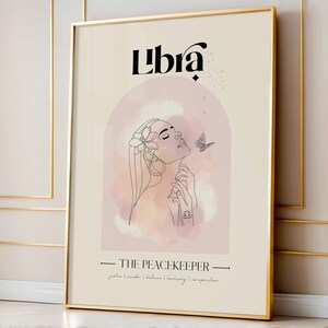 May include: A pink and white watercolour illustration of a woman with a flower crown and a butterfly. The text "Libra" is at the top of the image, and the text "THE PEACEKEEPER" is at the bottom. The text "justice | order | balance | harmony | inspiration" is below the text "THE PEACEKEEPER".