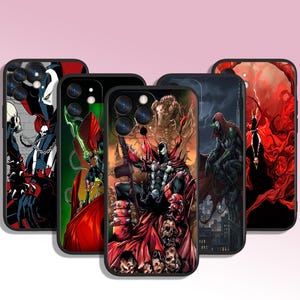 May include: A selection of black phone cases with comic book illustrations. The designs feature characters in action, with a colour scheme of red, black, and green. The cases have a glossy finish.