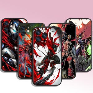 May include: A collection of phone cases featuring comic book art of the character Spawn. The cases display Spawn in various action poses, with a color palette dominated by red, black, and white. The cases have black borders.