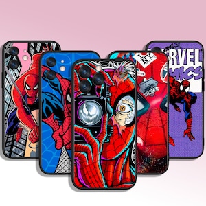 May include: Four different phone cases featuring Spider-Man designs. The cases are black with colorful images of Spider-Man in different poses. One case features a purple background with the text "Marvel Comics".