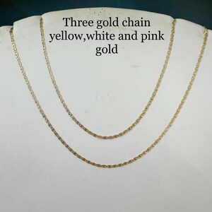 May include: Three gold chains, one yellow, one white, and one pink gold.