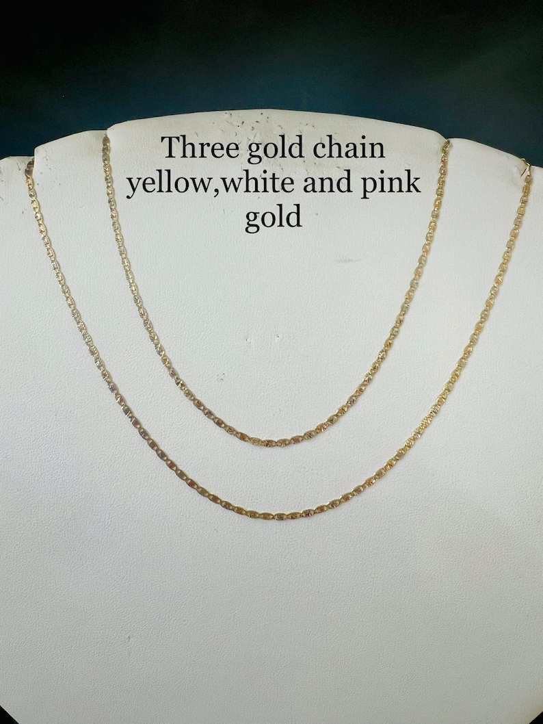 May include: Three gold chains, one yellow, one white, and one pink gold.
