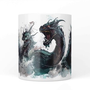 May include: White ceramic mug featuring a detailed illustration of a sea serpent with a menacing expression. The artwork showcases a dragon-like creature with dark green scales, red eyes, and an open mouth, set against a watercolor-style background.