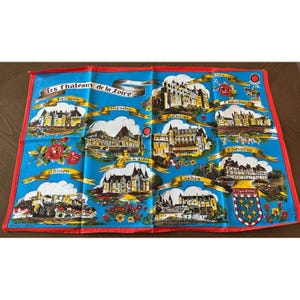 May include: A blue souvenir handkerchief featuring illustrations of Loire Valley chateaux. The handkerchief has a red border and includes the text "Les Chateaux de la Loire" and the names of various chateaux.