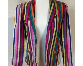 May include: A colorful striped blazer with a vibrant array of vertical stripes in shades of pink, purple, blue, green, yellow, orange, and gold. The blazer has a classic open front design with two small pockets.