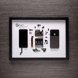 May include: A disassembled Google Pixel 1 smartphone displayed on a white background. The phone's components are labelled and connected by lines, showing the phone's internal structure. The phone's screen, camera, battery, and motherboard are visible.
