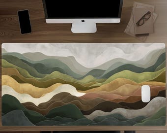 May include: A rectangular desk mat featuring a layered landscape illustration of rolling hills and mountains in shades of sage green, olive, mustard yellow, beige, and dark brown, with a white computer mouse resting on the right side.