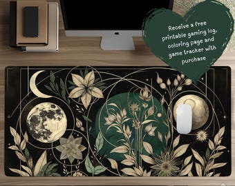 May include: A black and gold desk mat with a celestial and floral design. The mat measures 36 x 18 inches and features a moon, flowers, and botanical elements. A computer mouse sits on the mat. Text on the image reads: "Receive a free printable gaming log, coloring page and game tracker with purchase."