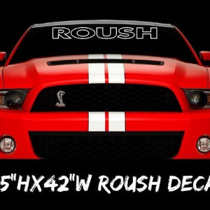 May include: Red car with white racing stripes and a black grille. The word "ROUSH" is displayed across the top of the windshield. A decal that is 4.5" high and 42" wide.