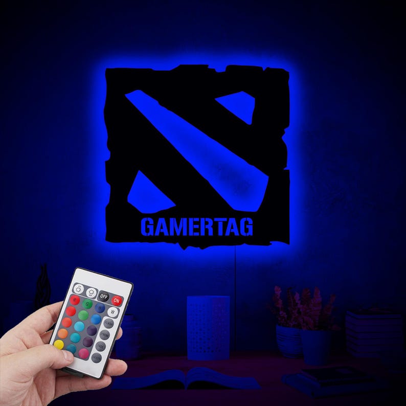 May include: A blue and black gamertag night light with a remote control. The remote has multiple color options.