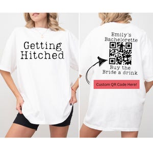 May include: White oversized t-shirt with the text "Getting Hitched" on the front and a QR code on the back with the text "Emily's Bachelorette Buy the Bride a drink Custom QR Code Here!"