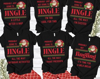 May include: Black t-shirts with Christmas-themed graphics and text. Each shirt features a Santa Claus illustration within a circular design, with the word "JINGLE" in large red letters. The shirts have different phrases like "A Little After a Nap".