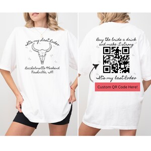 May include: White t-shirt with a black skull and crossbones design and the text "It's my Last Rodeo" and "Bachelorette Weekend Nashville, TN". The back of the shirt has a QR code and the text "Buy the bride a drink and make it strong" and "It's my last Rodeo Custom QR Code Here!"