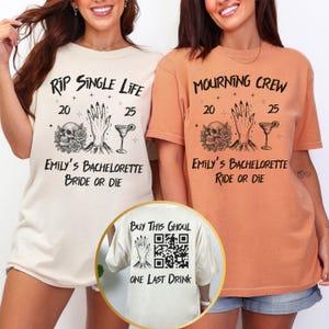 May include: Two t-shirts with gothic-themed graphics for a bachelorette party. One is cream-colored with "RIP SINGLE LIFE" and the other is orange with "MOURNING CREW". Both shirts feature a skull, hand, and cocktail glass. The back of one shirt says "Buy This Ghoul".