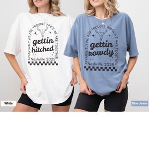 May include: Two oversized t-shirts with a skull graphic and text that reads "Apparently we are trouble when we are together, gettin hitched, Nashville 2025" and "Apparently we are trouble when we are together, gettin nowdy, Nashville 2025". The shirt on the left is white and the shirt on the right is blue.