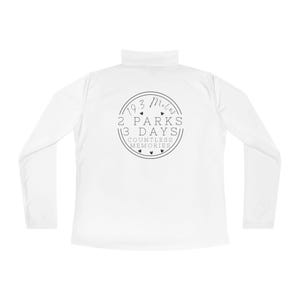 May include: White long-sleeve shirt with a black graphic of a circle with the text "193 Miles 2 Parks 3 Days Countless Memories" and small hearts.