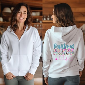 May include: White zippered hoodie with a floral design on the back that says "Registered Nurse" with a pink heart and a stethoscope.