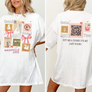 May include: White t-shirt with a front graphic featuring postage stamp designs with the text "Gettin' Hitched", "Emma's Last Rodeo Nashville 2025". The back of the shirt has a QR code and the text "Buy me a drink! It's my last rodeo".