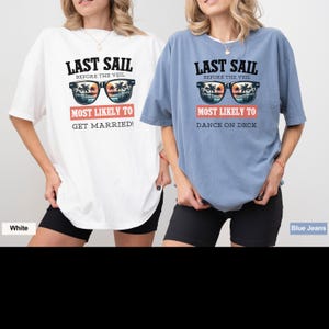 May include: Two oversized t-shirts with a graphic of sunglasses and palm trees. The white t-shirt says "Last Sail Before The Veil Most Likely To Get Married!" The blue t-shirt says "Last Sail Before The Veil Most Likely To Dance On Deck".