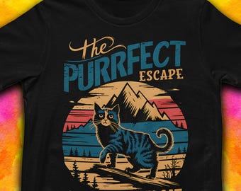 May include: Black t-shirt with a retro-style graphic of a cat in a mountain landscape. The text reads "The Purrfect Escape Nature & My Cat".