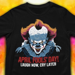 May include: Black t-shirt with a graphic of Pennywise the clown from the movie "IT" with the text "April Fools' Day! Laugh Now, Cry Later".