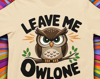 May include: A beige t-shirt with a cartoon owl and the text "Leave Me Owlone".