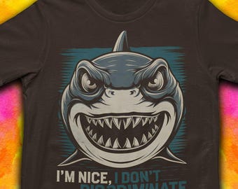 May include: A brown t-shirt with a graphic of a shark with a toothy grin. The text "I'm nice, I don't discriminate" is printed below the shark.