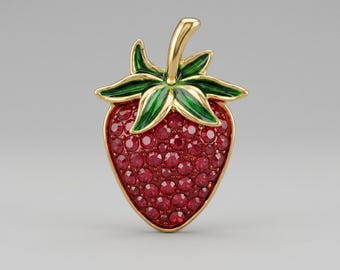 May include: A gold-toned strawberry brooch with a vibrant red, gem-studded body. The brooch features green enamel leaves and a gold stem. The strawberry design is a classic and elegant accessory.