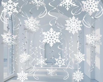 May include: White snowflake hanging decorations with silver swirl streamers. The snowflakes are cut from paper and are hanging from the ceiling.