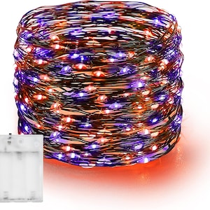 May include: A coiled strand of thin copper wire featuring small, evenly spaced LED lights that glow in alternating purple and orange colors. The wire is connected to a rectangular, translucent white plastic battery pack.