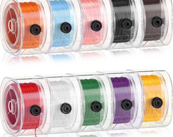 May include: Ten spools of thread in various colors, including orange, blue, pink, black, brown, red, white, green, purple, and yellow. The spools are clear plastic and the thread is wound around a central core.