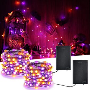 May include: Two coils of copper wire string lights featuring small purple and orange LED bulbs, each connected to a rectangular black battery pack with an on and off switch. The lights are illuminated against a dark, spooky background.