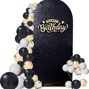 May include: An arched backdrop covered in black sequins featuring the text Happy Birthday in a cream-colored script font. The display is decorated with a cluster of balloons in black, white, gold, and clear balloons filled with gold confetti.