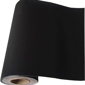 May include: A roll of black fabric, likely for crafts or upholstery, is rolled up on a cardboard tube.