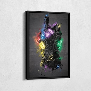 May include: Framed artwork featuring a stylized illustration of the Infinity Gauntlet. The black gauntlet is adorned with colorful, glowing gems. Splatter effects in vibrant hues of red, yellow, green, and purple add a dynamic touch to the design.