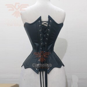 May include: Black leather corset with a lace-up back and a pointed bottom. The corset has a smooth, shiny finish and is designed to cinch the waist.