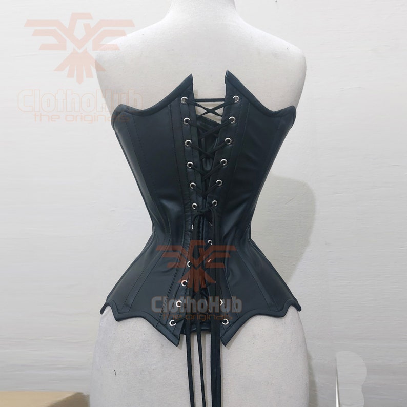 May include: Black leather corset with a lace-up back and a pointed bottom. The corset has a smooth, shiny finish and is designed to cinch the waist.